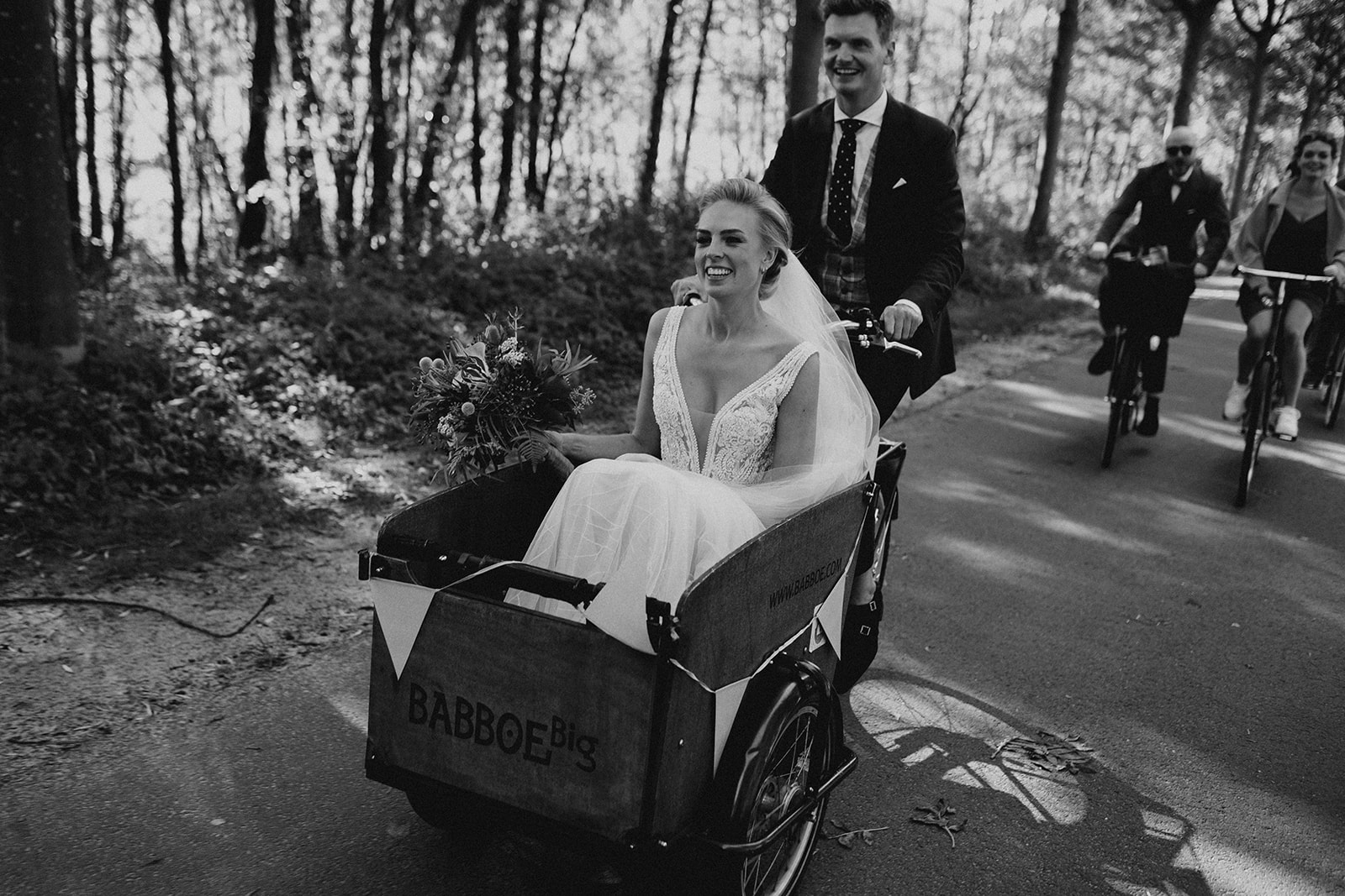 best wedding ride you can have, bike ride through the city of Amsterdam. Wedding couple on a bike.