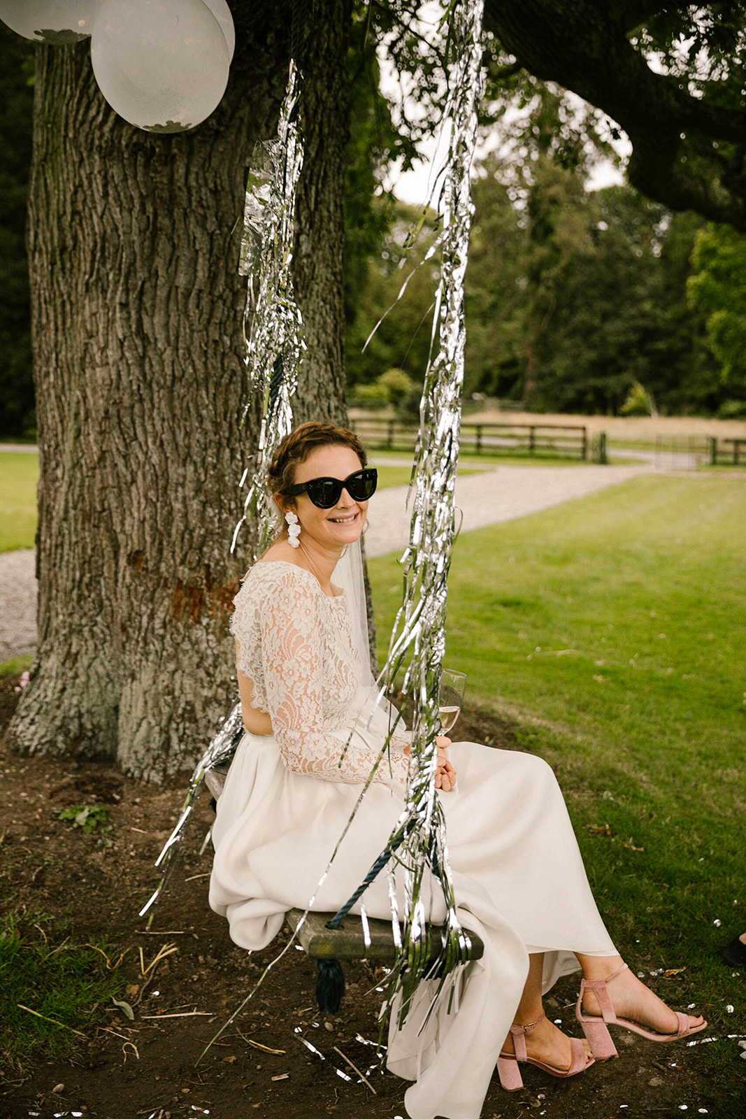 bride on swing with shades