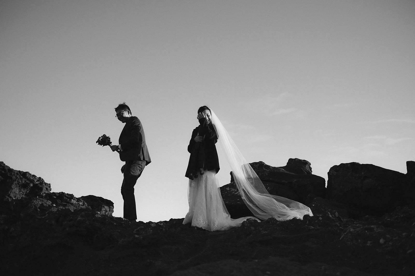 stunning black and white portrait of an Asian couple at Kleifarvatn in Iceland