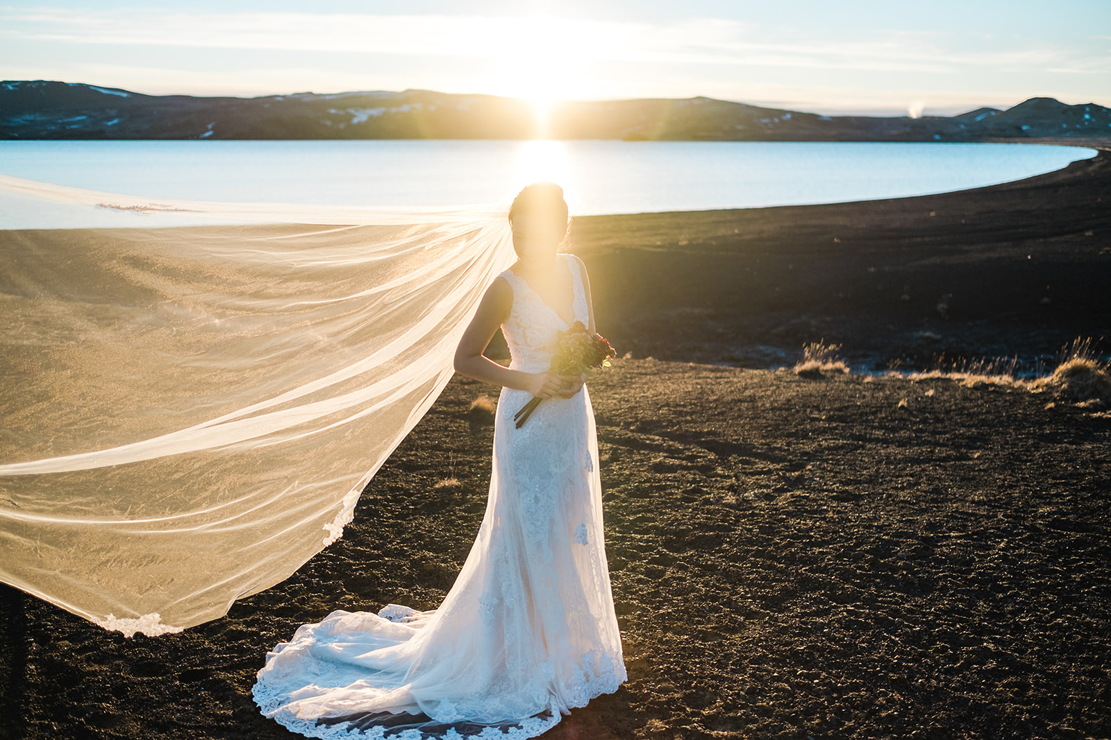 stunning portrait of an Asian bride at Kleifarvatn in Iceland
