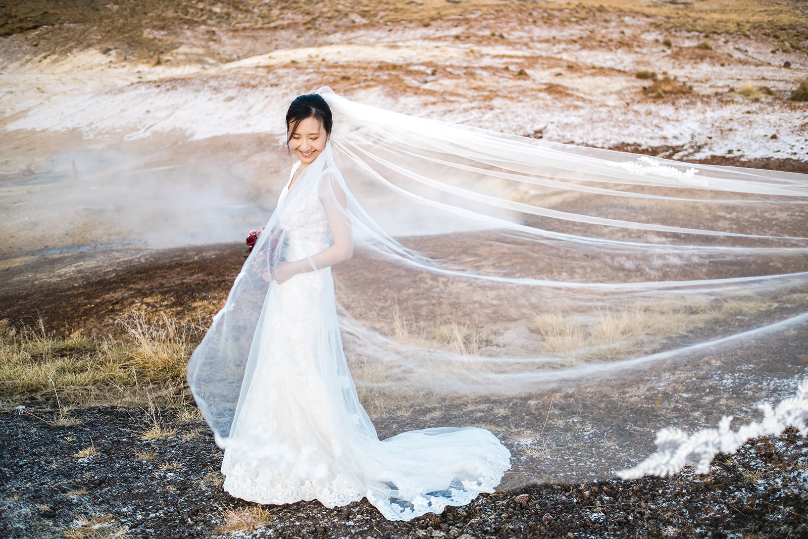 stunning portrait of an Asian bride at Seltún in Iceland