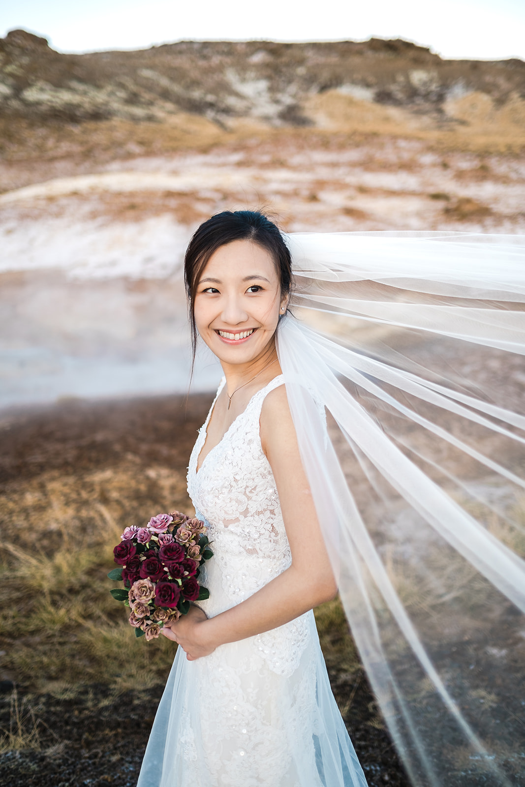 terrific portrait of an Asian bride at Seltún in Iceland