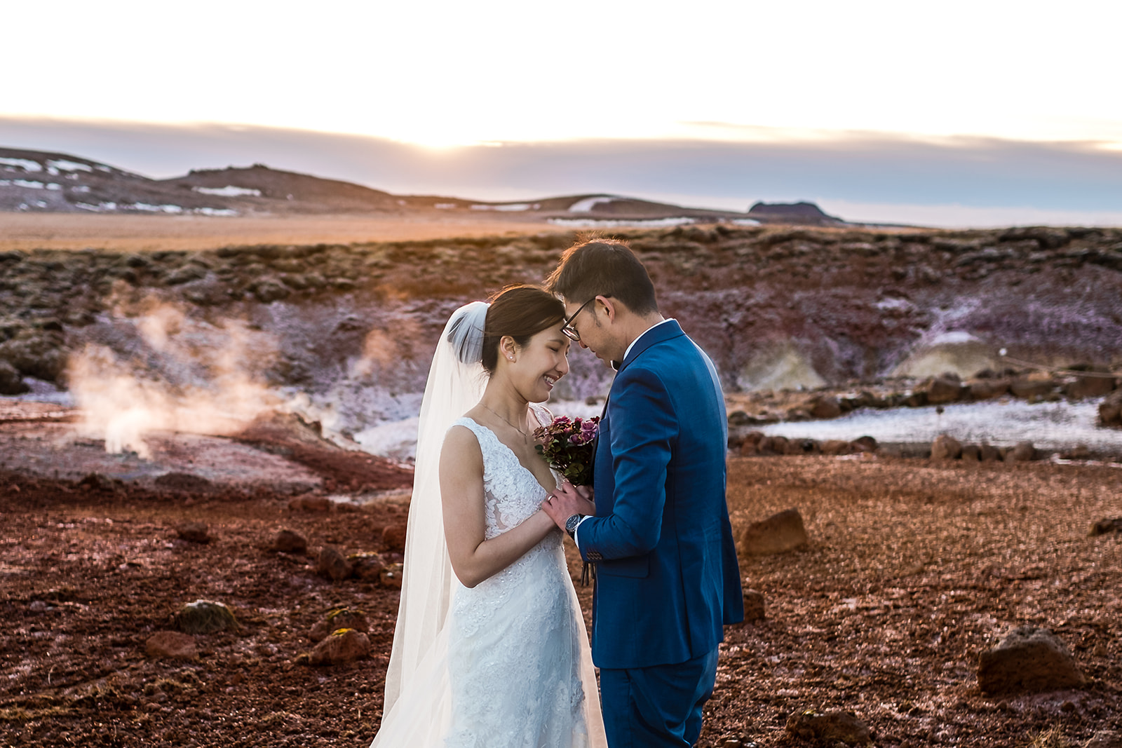 terrific portrait of an Asian couple at Seltún in Iceland
