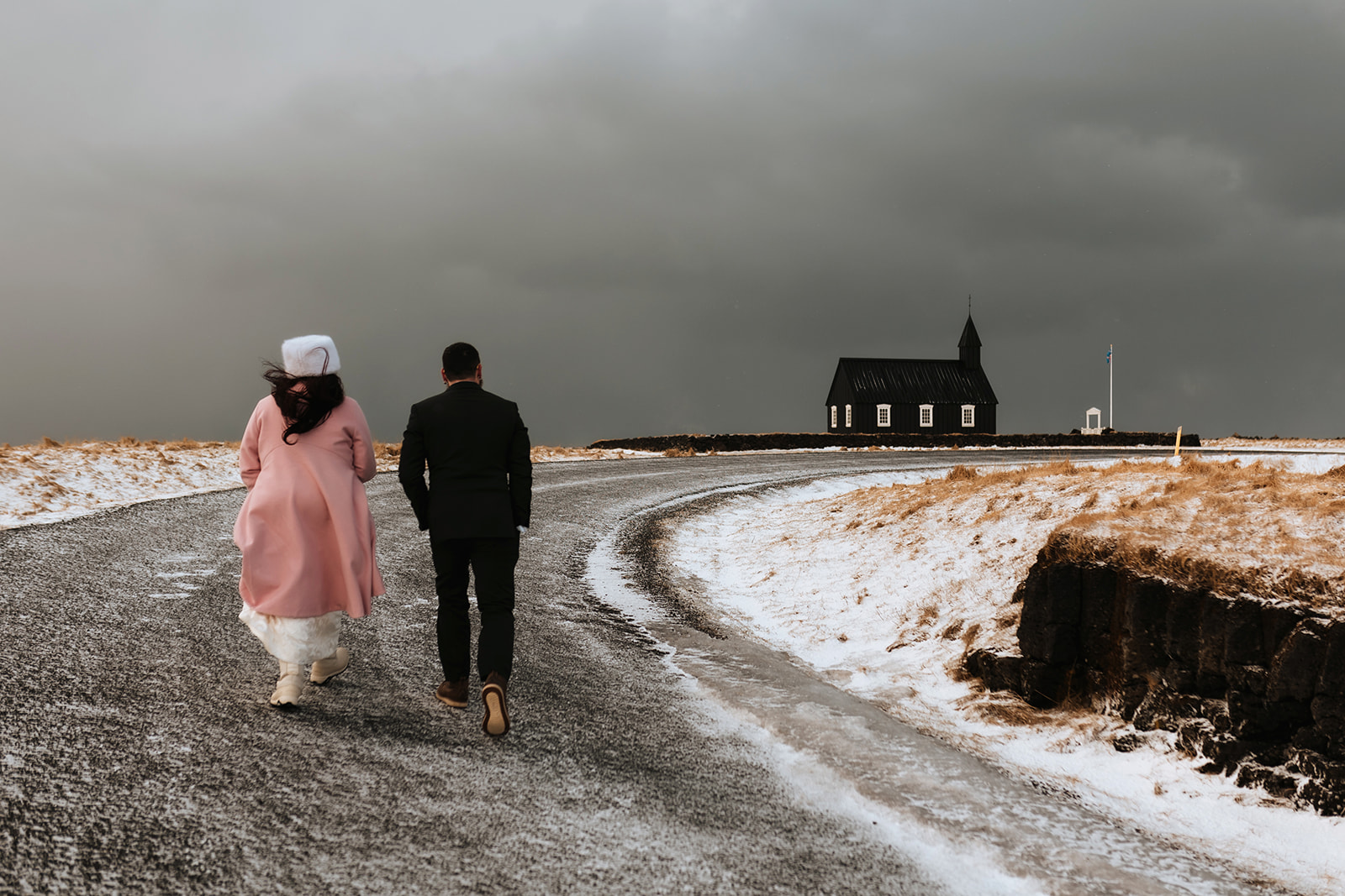couples who eloped in Iceland are walking to the church to get married in Iceland during the winter time in March
