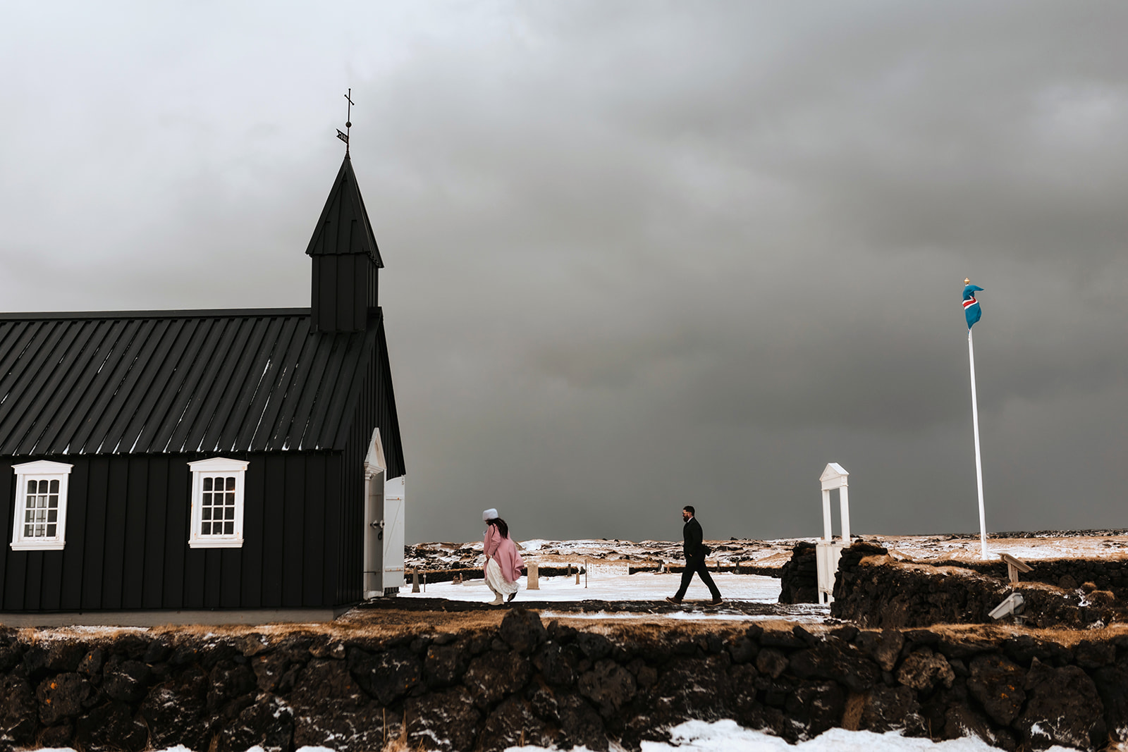 black Church Wedding in Iceland in winter time with dramatic sky