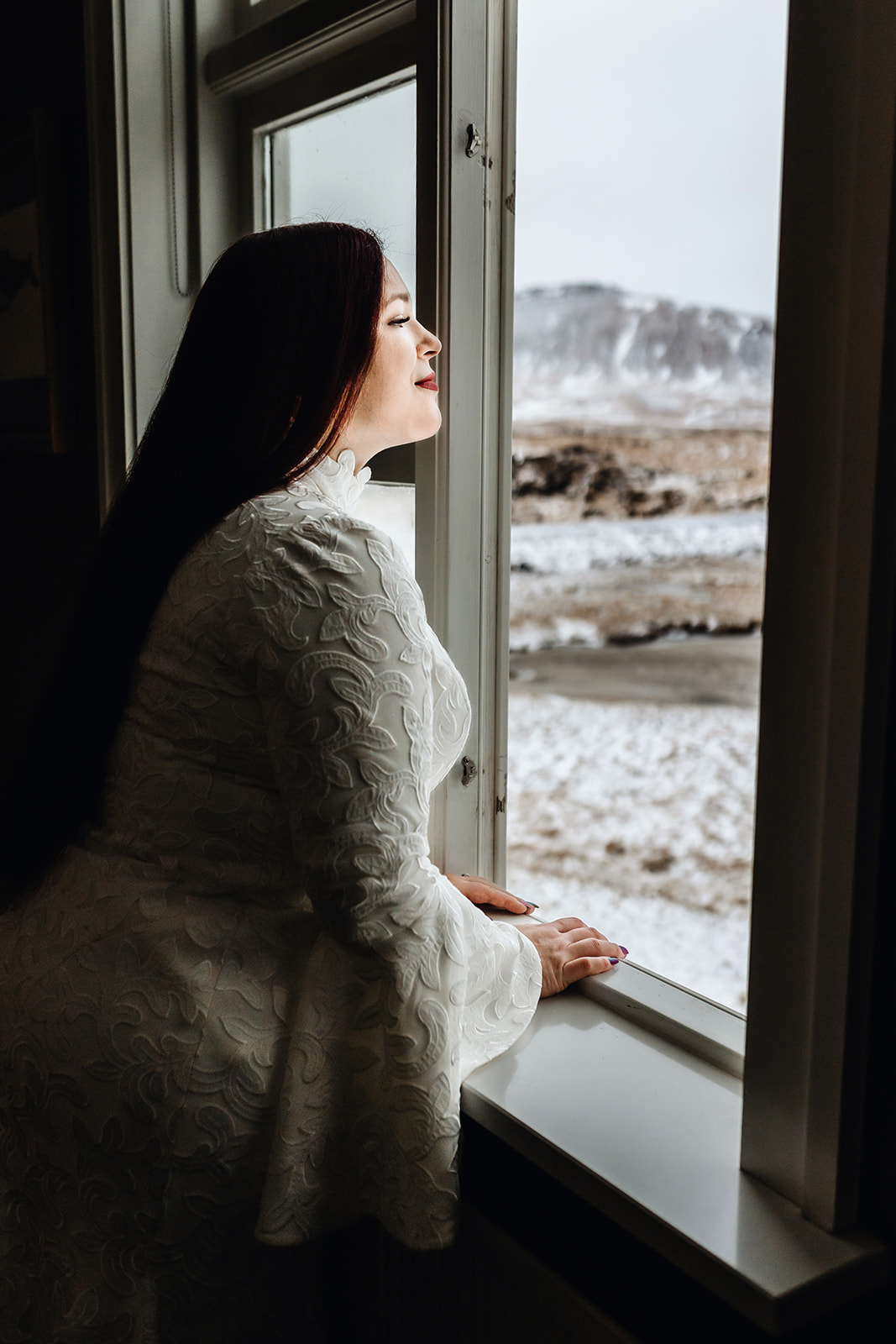 Bride who eloped in Iceland is looking out of the window on her Icelandic wedding day