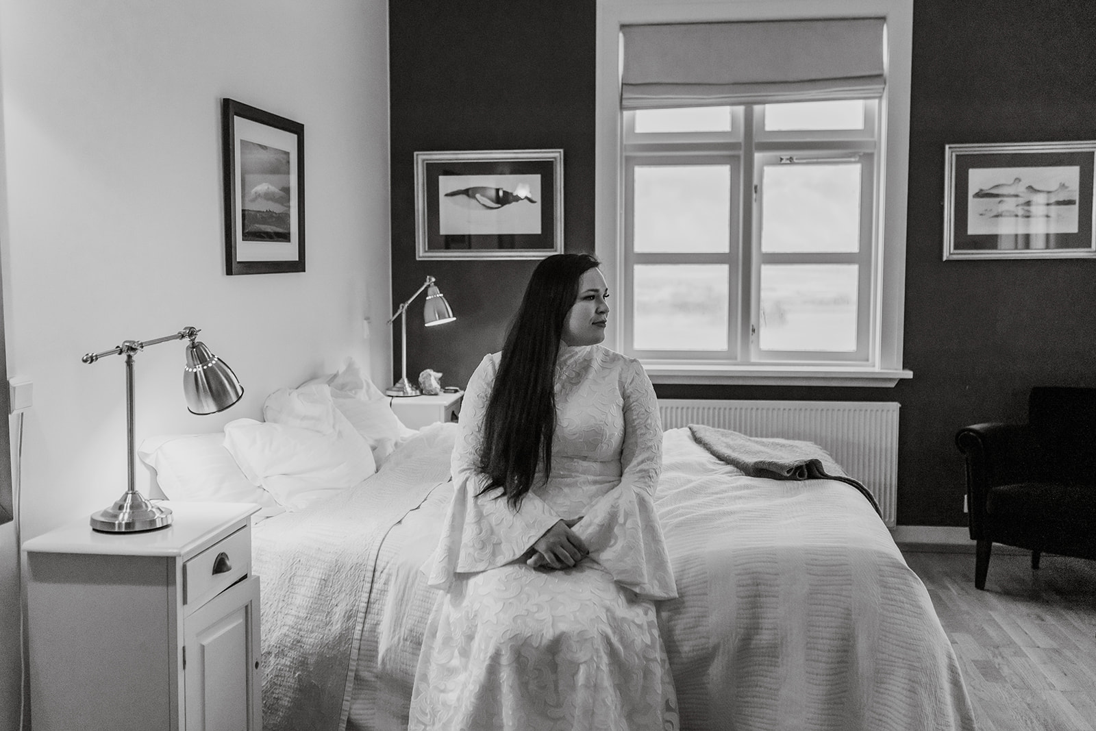 Bride is sitting on the bed waiting to get married in the black church in Iceland