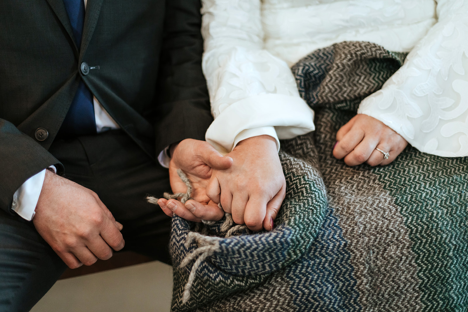 Couple who is getting married in Iceland are holding hands on their wedding day