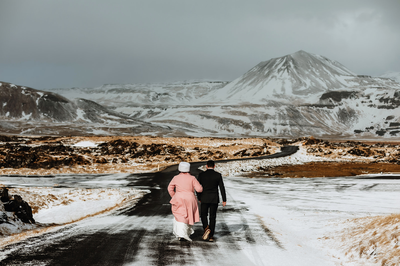 Married couple is walking back to the hotel after their wedding ceremony in Iceland