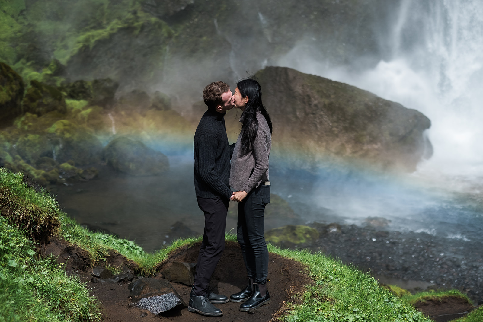 Surprise proposal at Kvernufoss in Iceland with rainbow