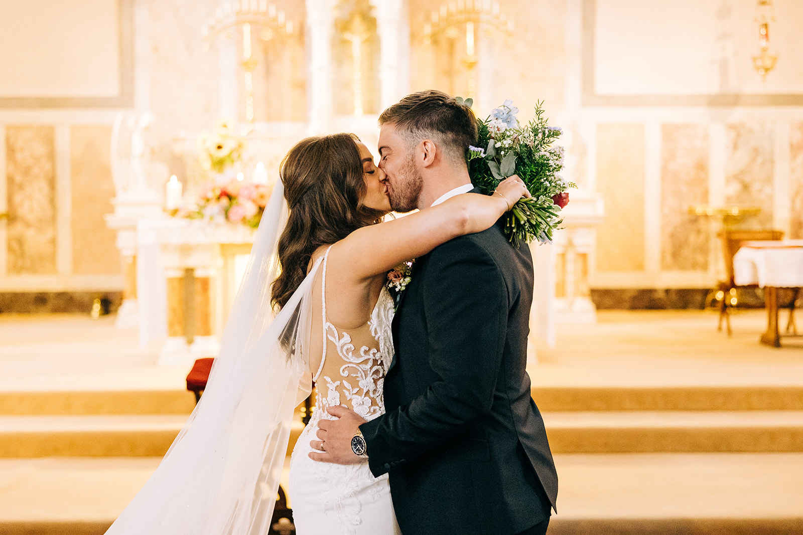 bride and groom exchange their first kiss