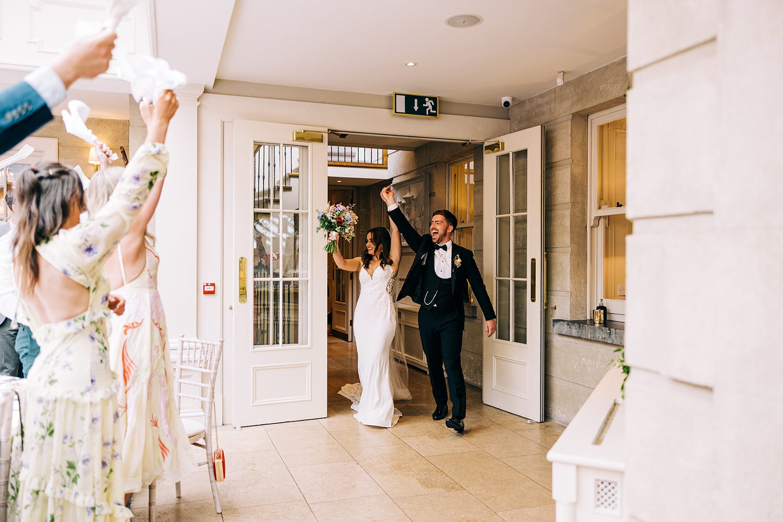 Esther and Gavin enter the orangery at tankardstown house to cheers and claps