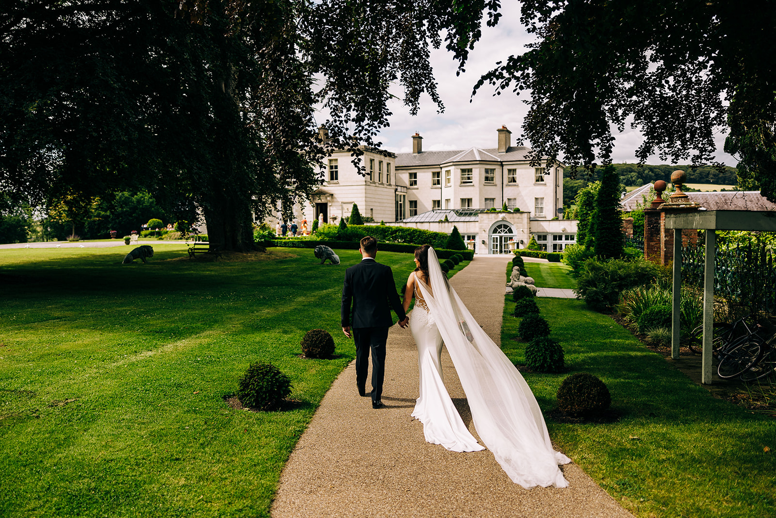 Esther and Gavin walk towards Tankardstown house to join the wedding party