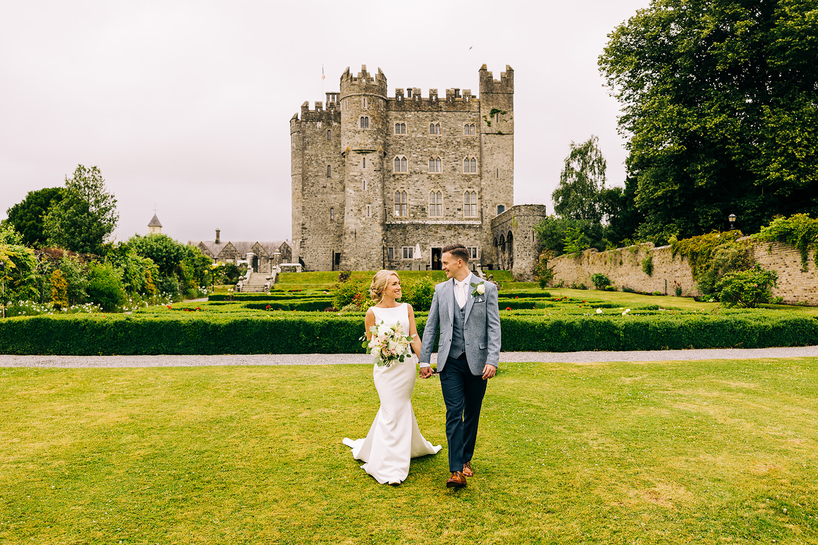 Newly married couple with kilkea castle in background