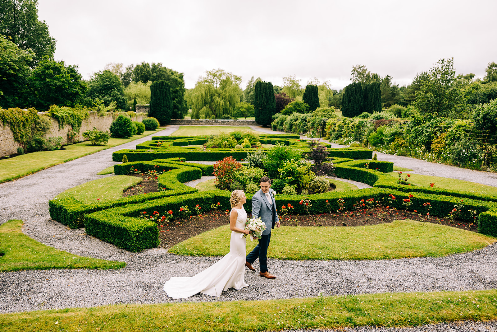 A newly married couple walking in kilkea castle having their wedding photos done
