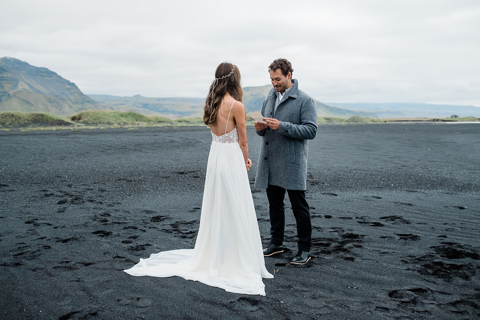 couple exchanging vows on a black sand beach in Iceland