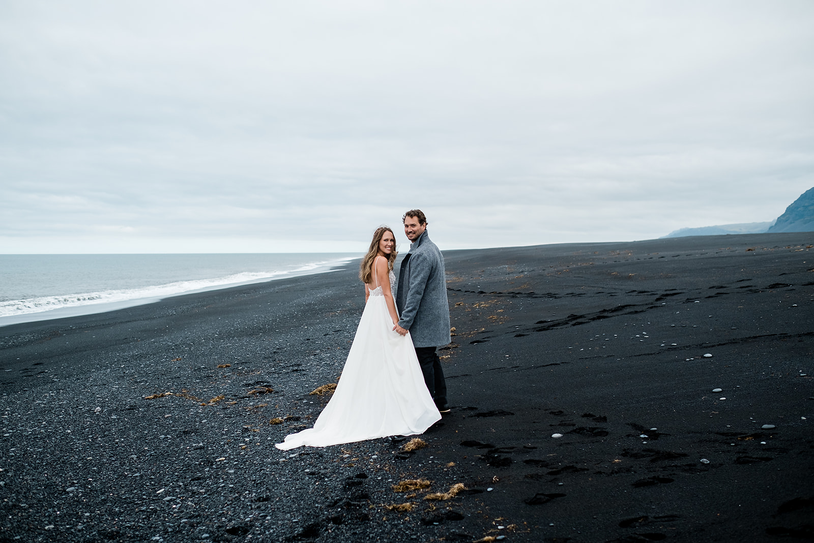 Just married couple on a black sand beach in Iceland