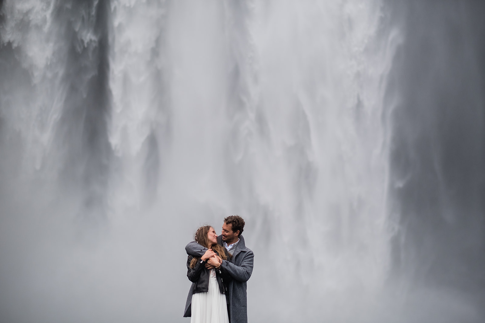 couple eloping in front of Skogafoss waterfall in Iceland