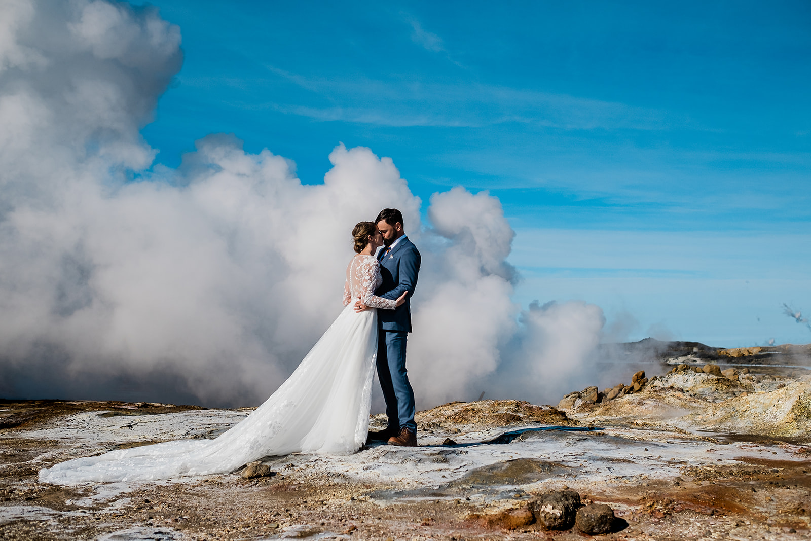 A stunning couple standing and hugging at Gunnuhver during their Ethereal Summer Elopement at Reykjanes Peninsula
