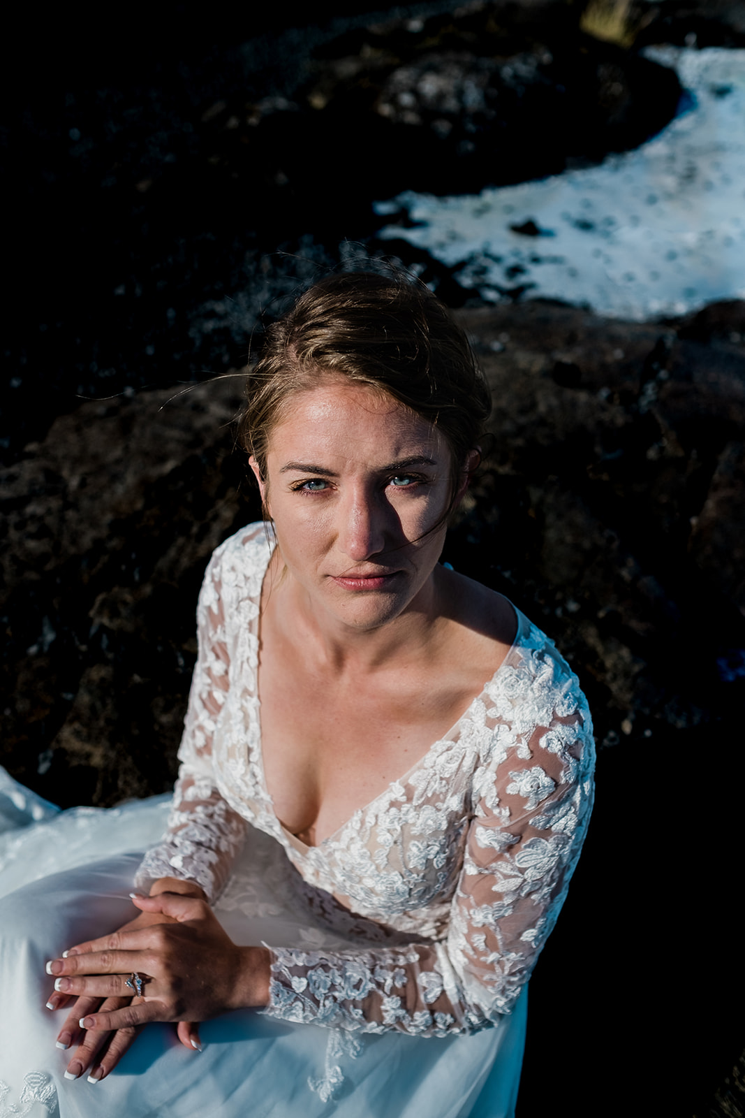 A stunning bride posing at the Blue Lagoon in Iceland during her Ethereal Summer Elopement at Reykjanes Peninsula