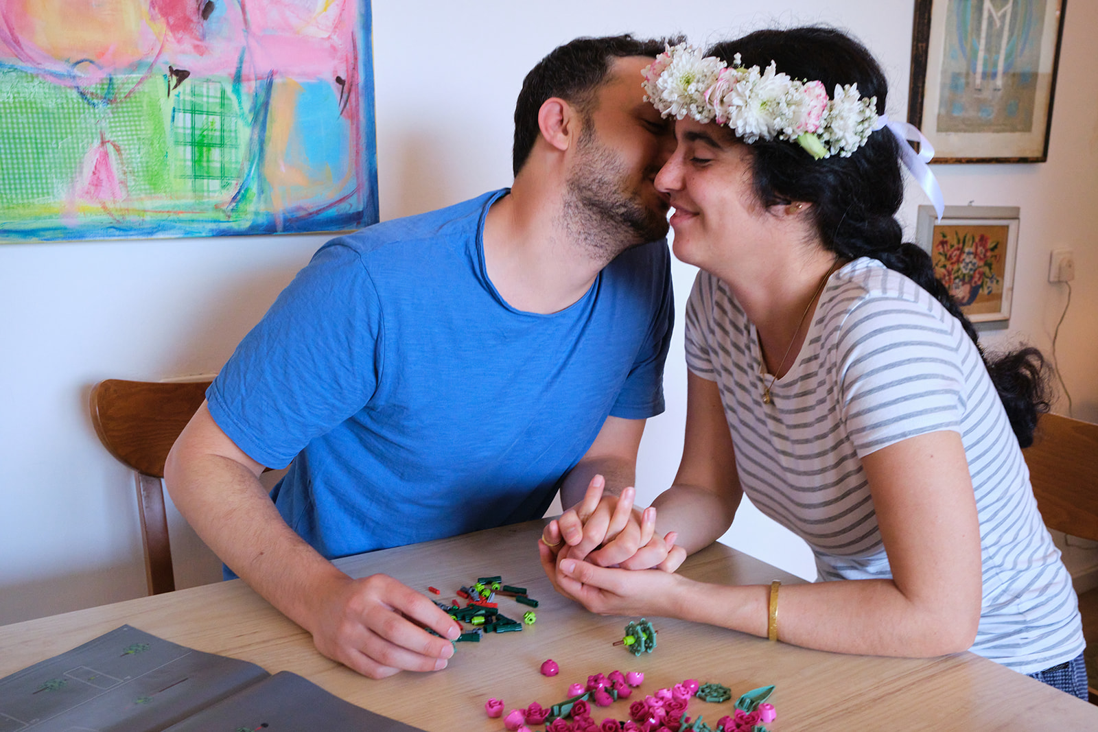 engaged couple kissing with flowers in her hair